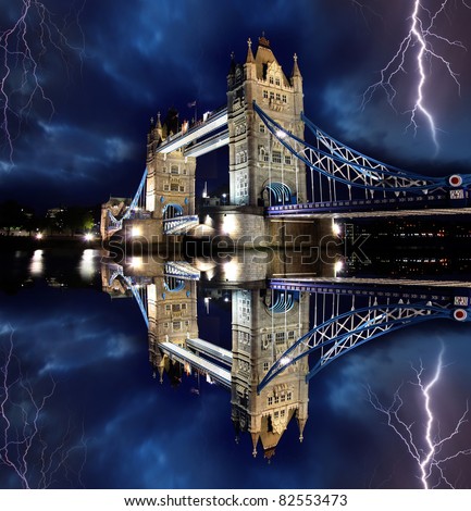 Tower Bridge with lightnings at stormy night in London, UK