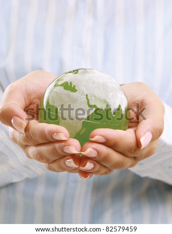 Hands holding a green earth