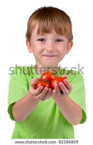 Boy with tomatoes isolated on a white background