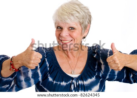 happy, mature woman with white hair, a smile and two thumbs up.