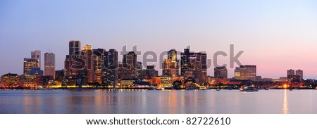 Boston downtown at dusk with urban buildings illuminated at dusk after sunset.
