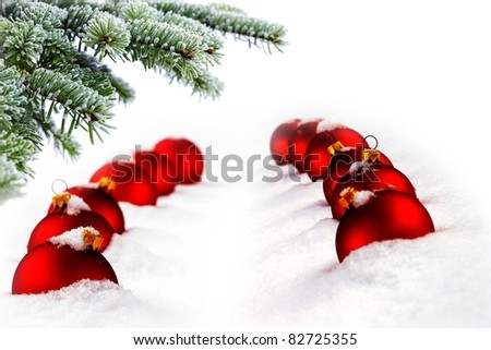 Christmas evergreen spruce tree and red glass balls on snow background