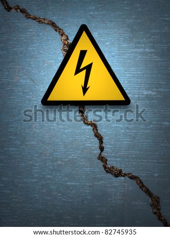 caution electricity sign on old wall