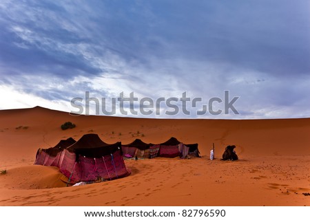 Sahara, Morocco: Bedouin nomad tent camp in the Sahara Desert, Morocco Royalty-Free Stock Photo #82796590