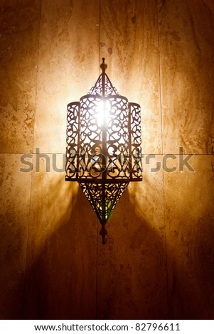 Morocco:  Ornate metal lamp in the wall of a mosque, Morocco. Royalty-Free Stock Photo #82796611