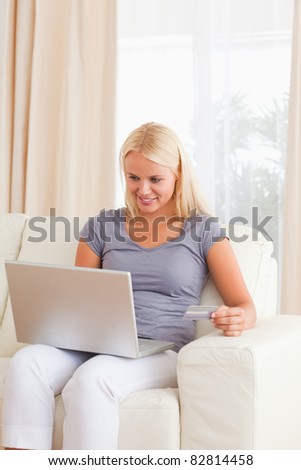 Portrait of a woman booking her holidays online in her living room
