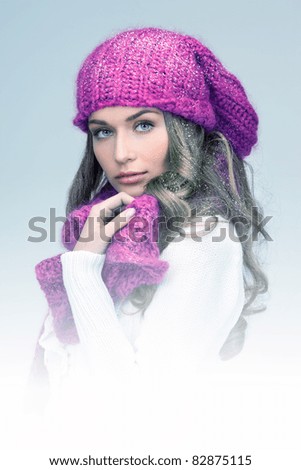 blue-toned picture of beautiful woman in winter hat
