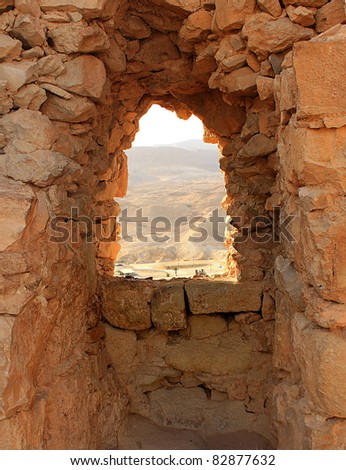 Ancient stone window with mountains in background