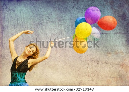 Redhead girl with colour balloons at blue sky background. Photo in old image color style.