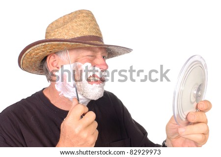 rough and tough cowboy shaving face with bowie knife