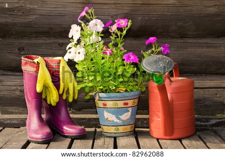 Garden tools (flower pot, watering can/ pot and rubber boots) horizontal image