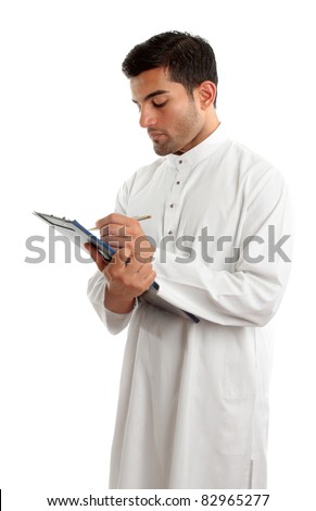 A traditionally dress middle eastern man writing in a clipboard folder.  White background.