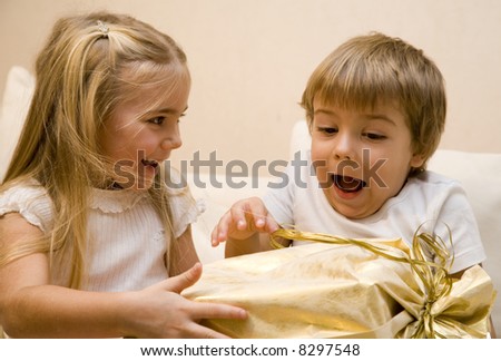 Little girl make a present to a little boy