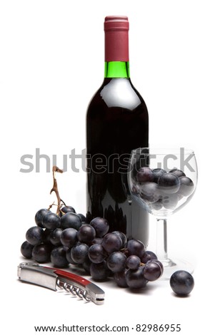 Bottle of red wine with grapes and corkscrew