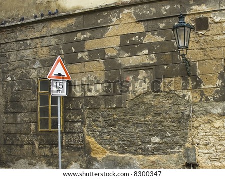 the traffic sign in front of old wall