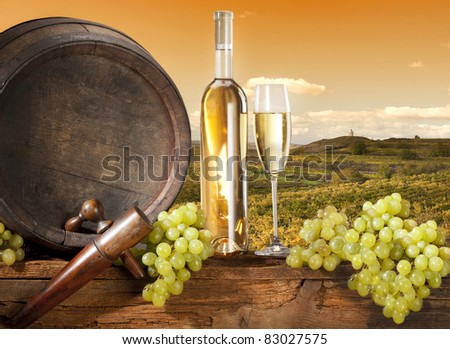 vineyard with barrel and white wine