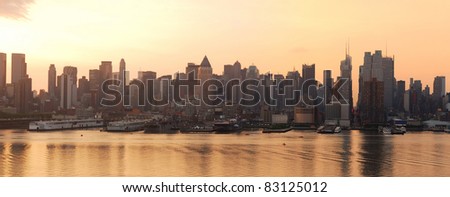 Manhattan urban skyline silhouette panorama in New York City at sunrise over Hudson River
