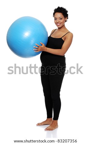 Pregnant woman exercises with big blue gymnastic ball