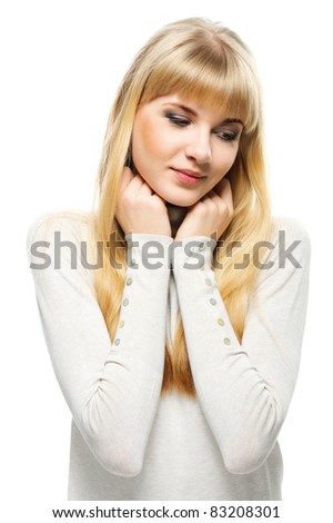 Portrait of young cute fair-haired woman wearing beige sweater against white background.