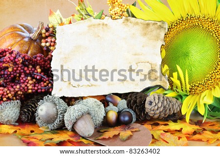 Blank card with copy space surrounded by autumn decorations and flowers.