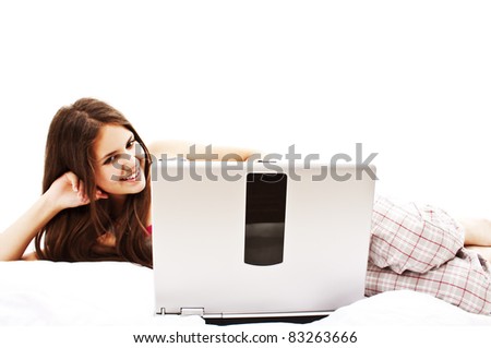 Attractive Young Woman Relaxing in Bed With Laptop Computer. Isolated on White Background
