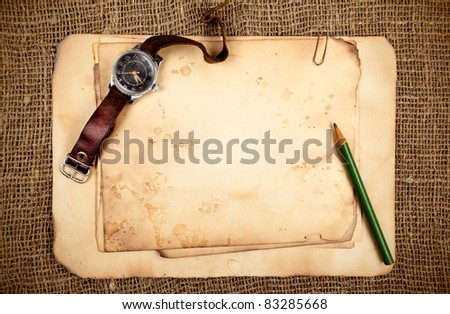 Still-life with old blank papers and wristwatch