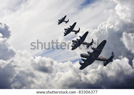 Flight formation of Battle of Britain World War Two consisting of Lancaster bombers banking right Royalty-Free Stock Photo #83306377