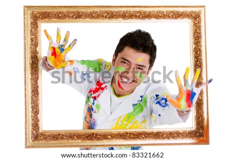 Happy male painter coming out from a frame having fun - isolated