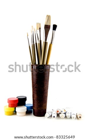brushes and paints on a white background