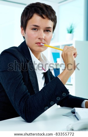 Photo of smart businesswoman looking at camera while planning her work