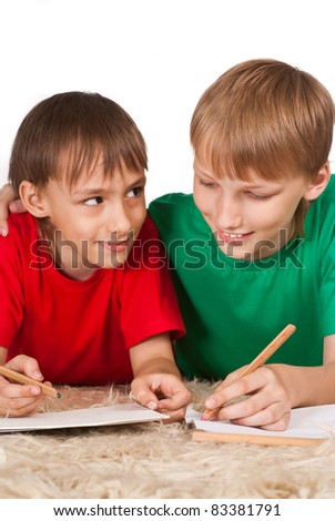 portrait of a two boys drawing on carpet