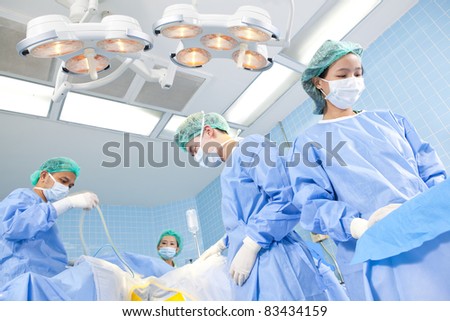 doctor in operation room with his team