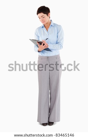 Woman writing on a clipboard against a white background