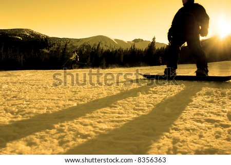 Young snowboarder in glitter of the sun