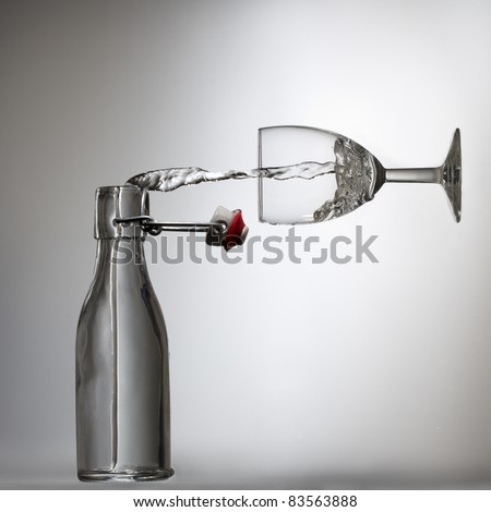 Pouring water in a glass, illusion Royalty-Free Stock Photo #83563888