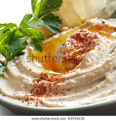 Bowl of hummus topped with paprika.  Traditional chickpea dip. Royalty-Free Stock Photo #83596228