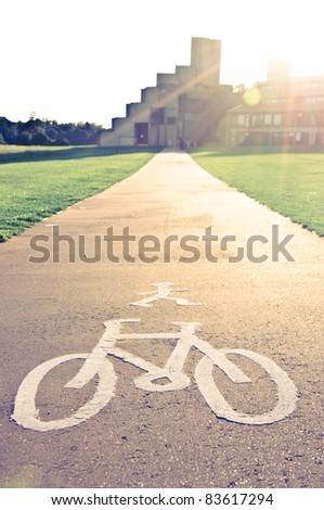 Bicycle symbol on street at sunset