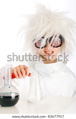 Child dressed as a mad scientist performing an experiment with beakers and colorful fluid.