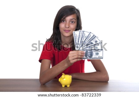brunette teen girl with piggy bank and bills of 100 euros on white background