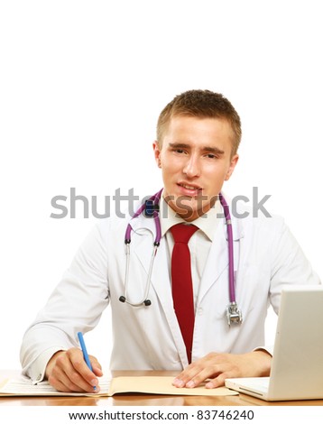 A male doctor working at desk, isolated on white