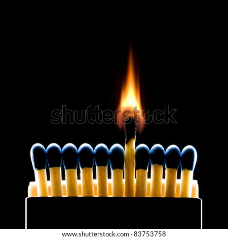 Many dark blue matches on a black background (one match burns). Royalty-Free Stock Photo #83753758