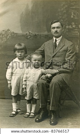 Vintage photo of father with sons (twenties)