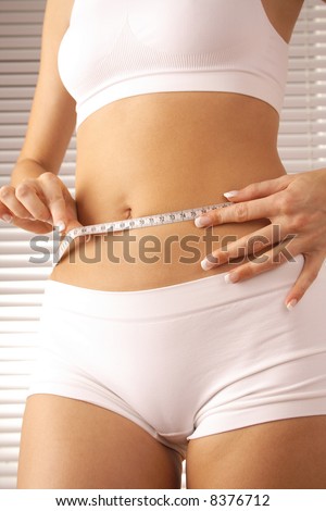 female body with measure tape. fitness, sport, healthy life