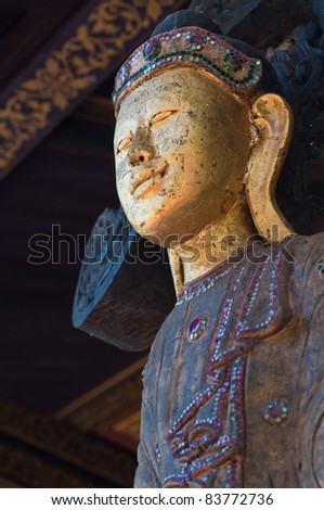 Standing wood buddha at the temple, Thailand.