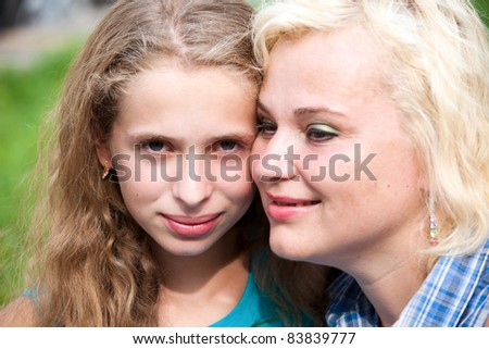 Happy mother and daughter in park