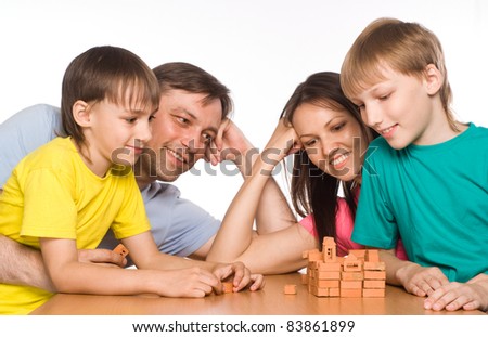 portrait of a cute family playing at table