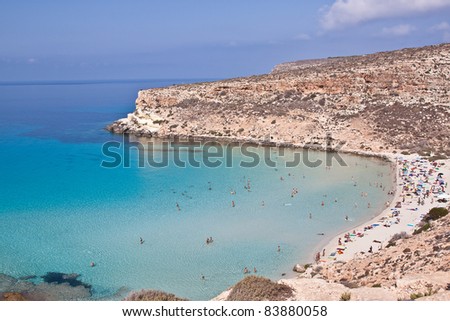 Pure crystalline water surface around an island (Lampedusa) Royalty-Free Stock Photo #83880058
