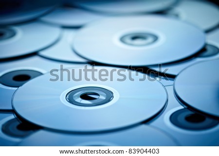 blue tinted close-up of a stack of cd-roms Royalty-Free Stock Photo #83904403