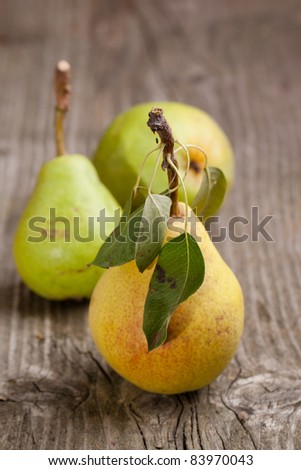 Three fresh pears on old wooden table
