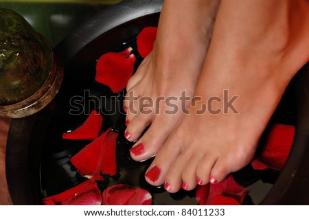 Close up of a woman's feet on a rose pedal bath, Royalty-Free Stock Photo #84011233